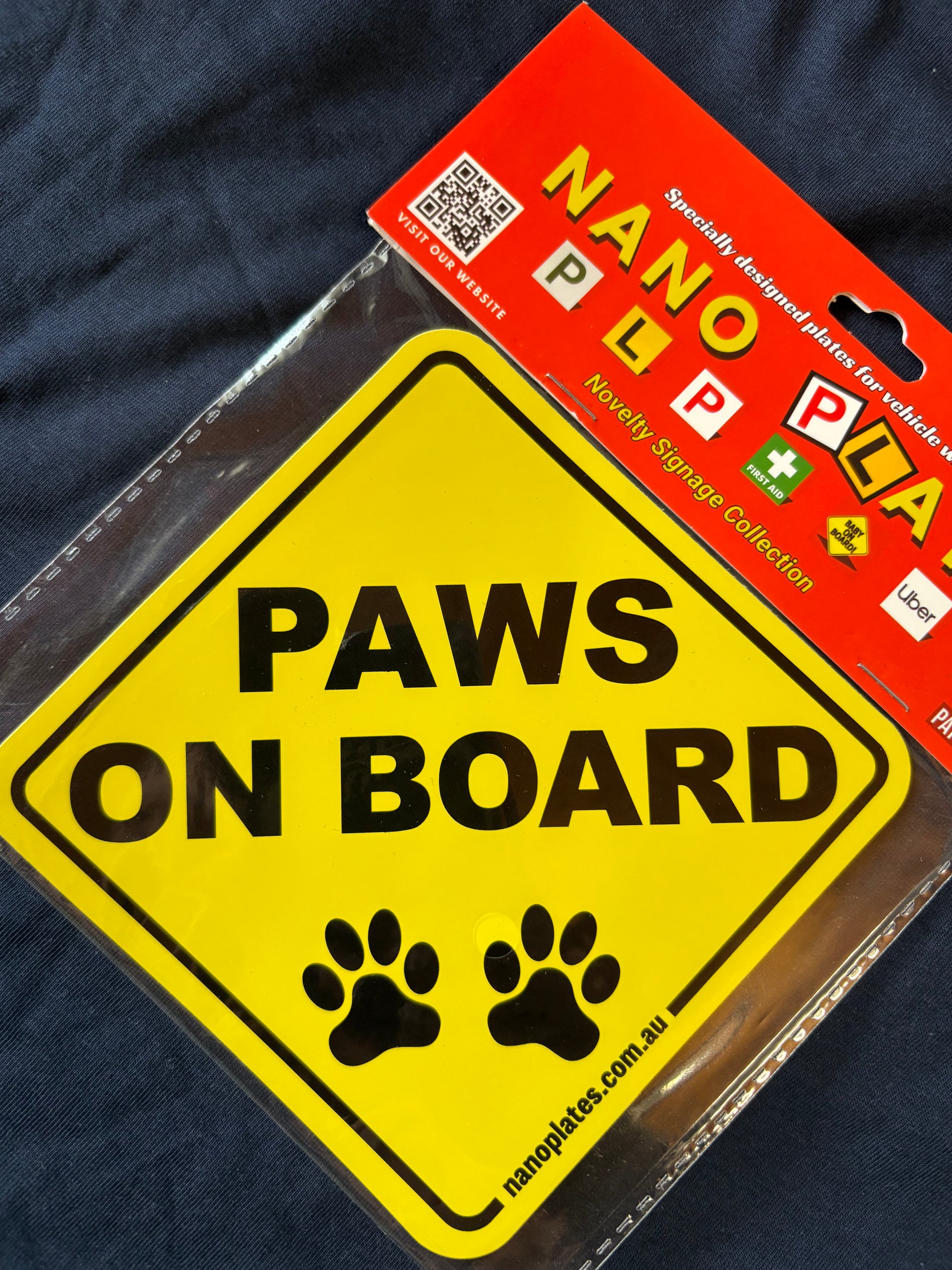 Yellow 'Paws on Board' sign with nanoplates label
