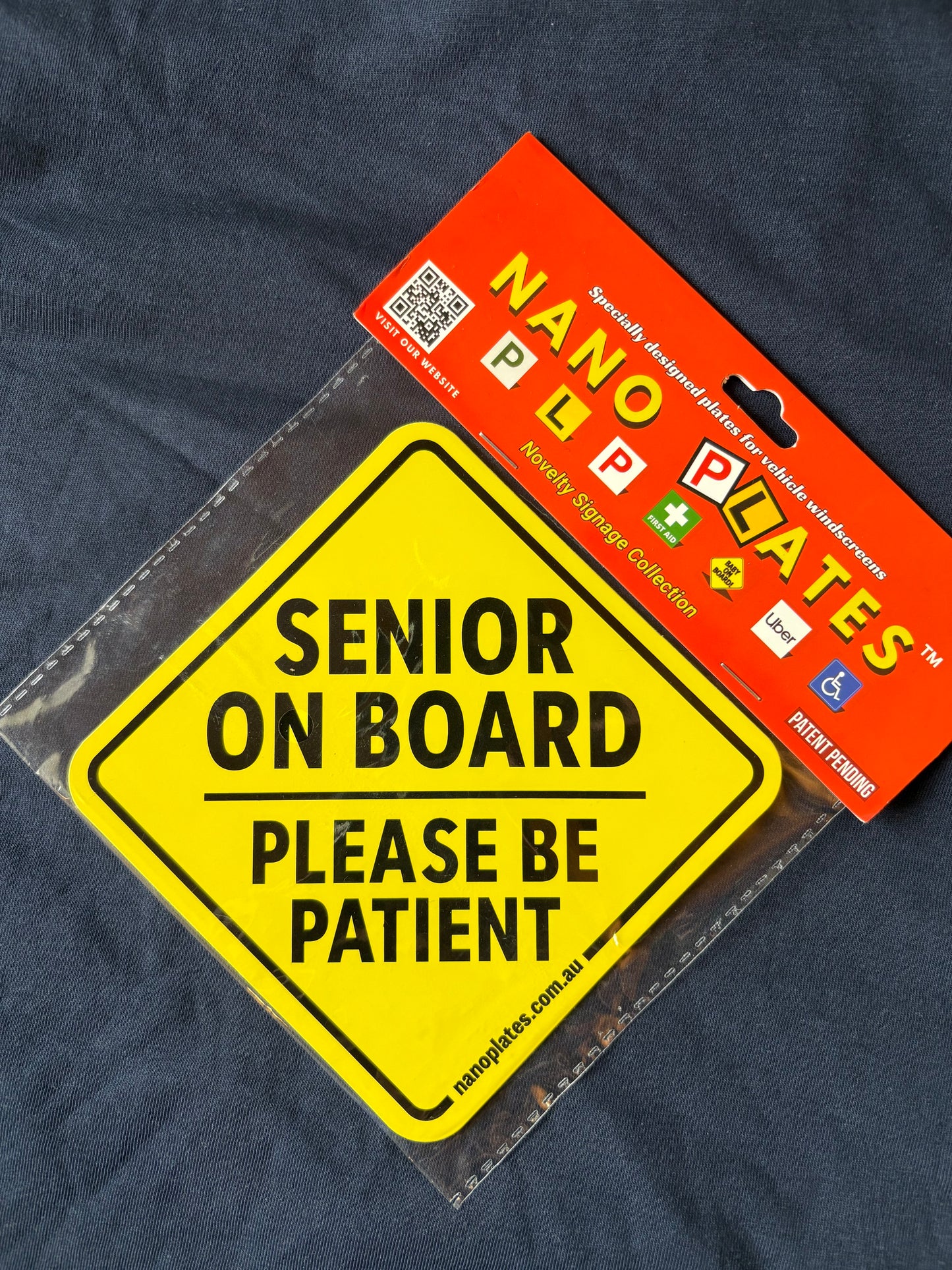 Yellow 'Senior on Board' sign with nanoplates label