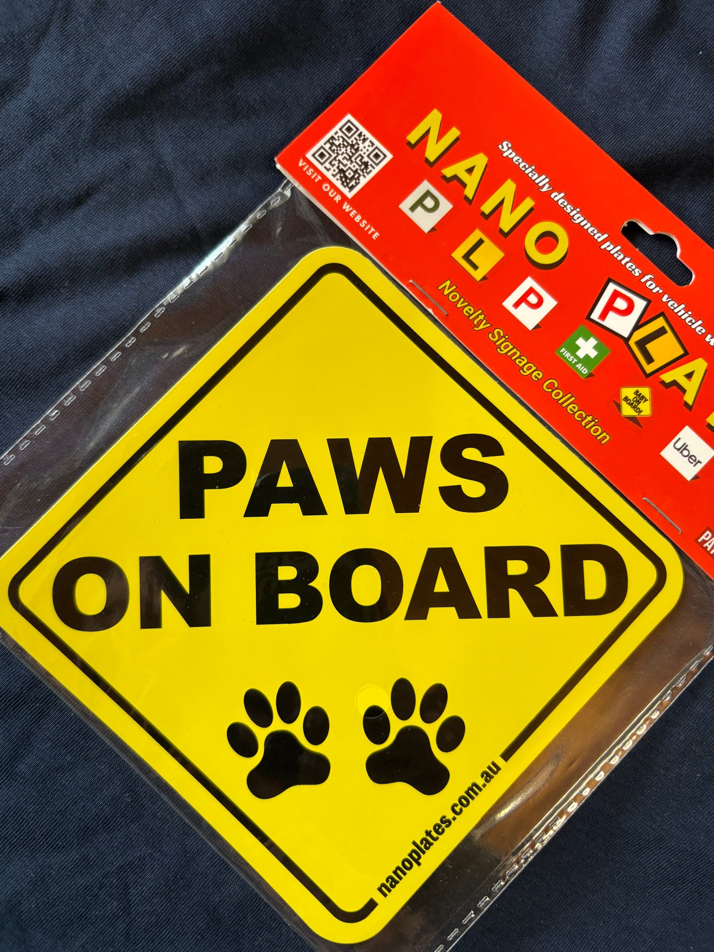 Yellow 'Paws on Board' sign with nanoplates label